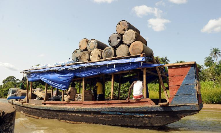 Products of illegal oil refineries in jerry cans are ferried to the market in Bayelsa State of Niger Delta on April 11, 2013 